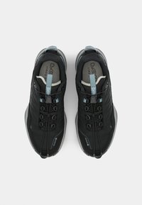 Black athletic shoes with a streamlined design, featuring gray accents, a textured upper, and elastic laces, viewed from above.