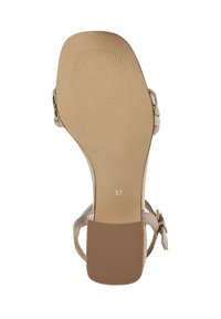 Sandale à talons hauts beige avec une semelle texturée et une finition lisse et brillante. Taille 37 indiquée sur la semelle. Détail de sangle ajustable.