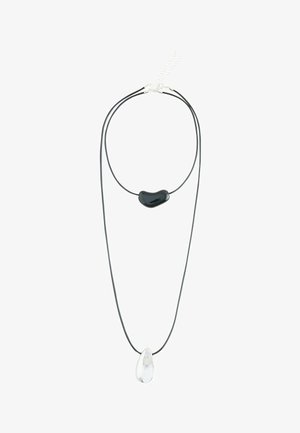 Double-layer black cord necklace with a glossy black irregular bead on the shorter layer and a clear teardrop pendant on the longer layer.
