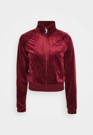 Veste zippée en velours bordeaux avec col montant, poignets élastiques et "Juicy Couture" brodé sur la poitrine gauche.