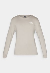 Langarmshirt in Hellbeige, aus weichem Material. Verfügt über einen runden Ausschnitt und ein kleines weißes Logo auf der oberen linken Seite.