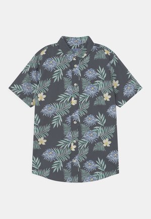 Camisa de manga corta con botones, de fondo oscuro, con estampado de hojas de palmera verdes y flores tropicales azules y blancas.