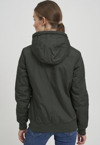 Dark green, hooded jacket with a smooth, slightly shiny texture. Features a fitted waistband and elastic cuffs for a snug fit.