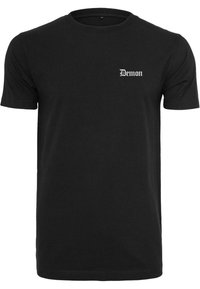 Černé bavlněné tričko s krátkým rukávem, kulatým výstřihem a bílým potiskem "Demon" v stylizovaném písmu na levé části hrudi.