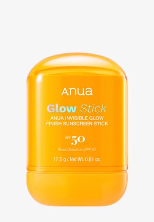 Pomarańczowy pojemnik na sztyft oznaczony Anua Glow Stick Invisible Glow Finish Sunscreen z SPF 50, 17,5 grama.