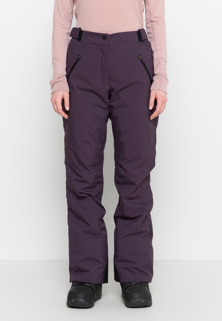 Lila Schneehose mit verstellbarem Bund, seitlichen Reißverschlusstaschen und strukturiertem Stoff. Robustes Design geeignet für Winteraktivitäten.