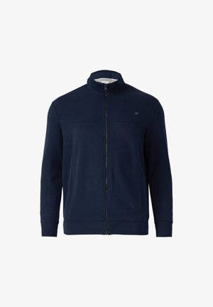 Chaqueta de cremallera de color azul marino en suave tejido, con cuello alto, mangas largas y un logo sutil en el pecho. Textura suave, diseño ajustado.