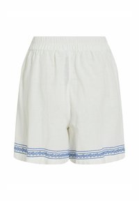 Short en lin blanc avec taille élastiquée et motif décoratif bleu en volute le long de l'ourlet sur les deux jambes.