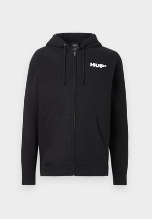 Crna zip majica s kapuljačom, prednjim džepovima i bijelim "HUF" logom na gornjem lijevom dijelu prsiju.