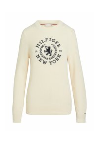 Cream ribbed knit sweater featuring a black graphic logo with a lion, surrounded by laurel leaves, and ribbed cuffs.