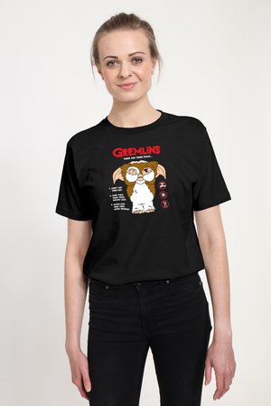 Black cotton t-shirt featuring a colorful Gremlins graphic, text, and three rules illustrated with cartoon-style images.