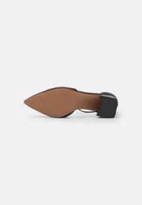 Black high-heeled shoe with a pointed toe and a square heel; smooth texture with a brown rubber sole. Minimalist design, no visible patterns.