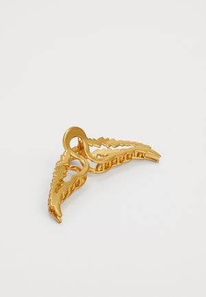 Gold hair clip featuring a leaf design with textured edges and a curved center, made of metal with a smooth finish.