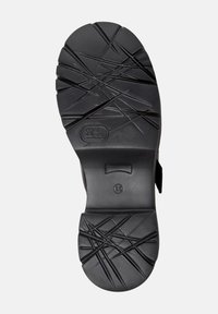 Black rubber sole with textured grip patterns, featuring a round toe and a panel for adjustment. Size indicator '38' embossed.