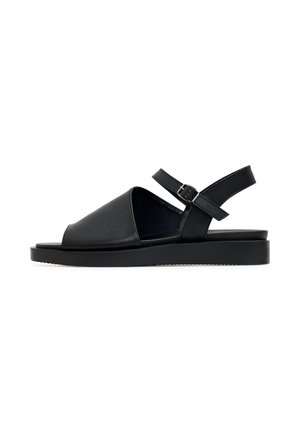 Schwarze Ledersandale mit breiter Vorderöffnung, verstellbarem Knöchelriemen und flacher Gummisohle. Minimalistisches Design mit glatter Textur.