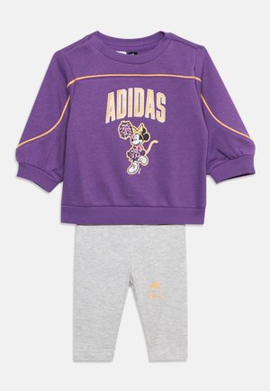 Hanorac mov Adidas cu grafică Minnie Mouse ca majoretă și colanți gri cu logo-urile Adidas și Disney.