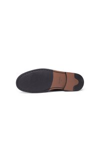 Black rubber shoe sole with textured grip pattern, featuring a brown leather accent and branding in the midsection.