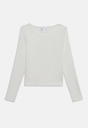 T-shirt blanc court à manches longues avec col rond et logo GAP discret brodé sur la poitrine.