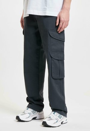 Dark gray cargo pants with multiple flap pockets, straight-leg design, and a smooth texture. Worn with white athletic shoes.
