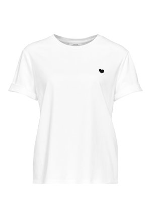 T-shirt en coton blanc avec des manches courtes retroussées, arborant un petit motif en forme de cœur noir sur la poitrine gauche. Encolure ras du cou classique.