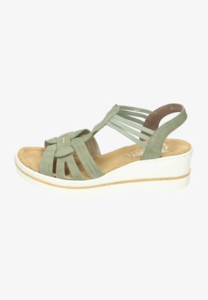 Green suede wedge sandal with multiple straps, a bow accent, and a white sole. Features a soft insole with a textured finish.