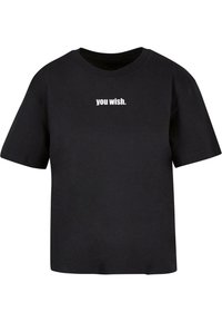 Black cotton t-shirt with short sleeves and a crew neckline. The front features white text that reads "you wish." Text is centrally placed.
