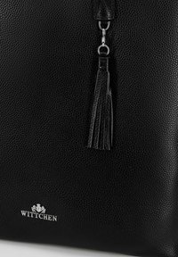 Borsa a tracolla nera in pelle testurizzata con logo argentato e dettaglio a nappina decorativa. Il materiale presenta una finitura a granuli.