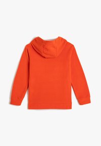 Jasnopomarańczowa hoodie rozłożona płasko, pokazująca plecy, z długimi rękawami i ściągaczami.