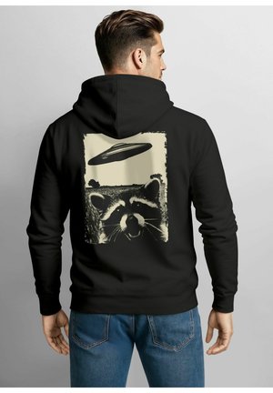Black hoodie with a large graphic on the back featuring a raccoon and a UFO, printed in cream. Soft texture, regular fit.