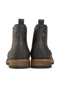 Vegan ankle boots in dark gray faux leather, featuring elastic side panels, a flat wooden heel, and a simple design with minimal accents.