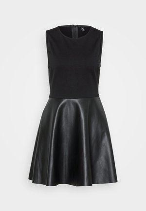 Black dress with a sleeveless fitted top made of soft fabric and a flared, shiny leather skirt. Features a back zipper closure.