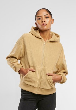 Beige Kapuzenzipfel-Sweatshirt mit strukturiertem Rautenmuster, Kängurutaschen und gerippten Bündchen, gestaltet für die Freizeit.