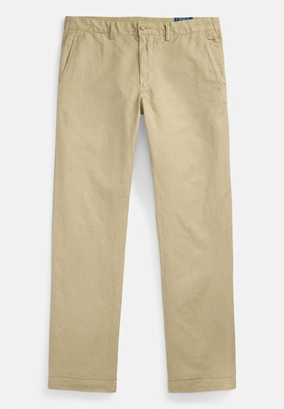 Bēša krāsas chino bikses no viegla auduma, ar taisnu staru griezumu, divām priekšējām kabatām, pogas aizdari un izšūtu apmali.