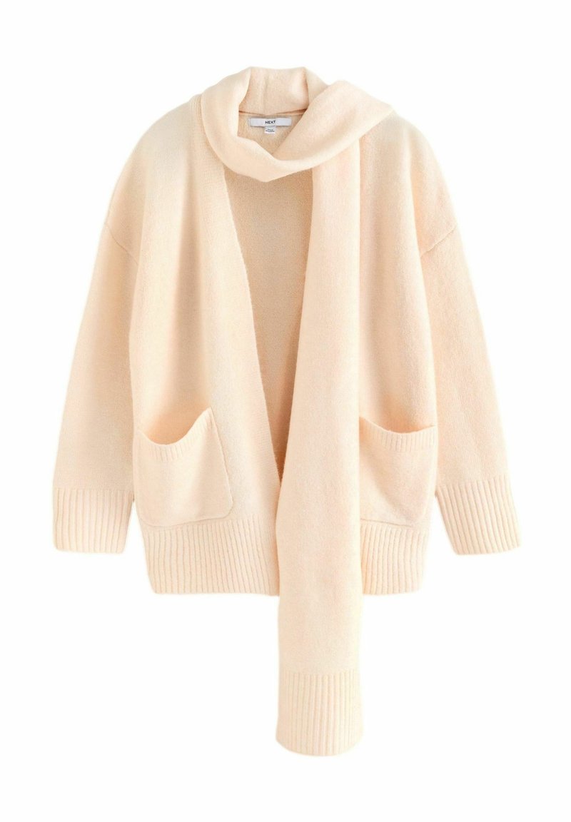 Licht perzikgekleurde gebreide cardigan met een omslagkraag, open voorkant, geribbelde manchetten en twee voorzakken. Zachte textuur, losvallend ontwerp.