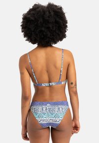 Bikini top and bottom set in blue, purple, and white patterns; adjustable straps; printed geometric design; smooth texture.