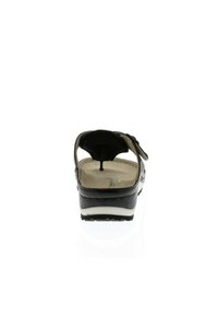 Black sandal with adjustable strap, open back, cushioned insole, and a contoured footbed. The sole is slightly elevated and textured.