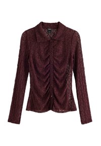 Bordeaux blonde bluse med lange ærmer, rynket frontdetalje og knaplukning. Har en klassisk krave og struktureret blomster mønster.