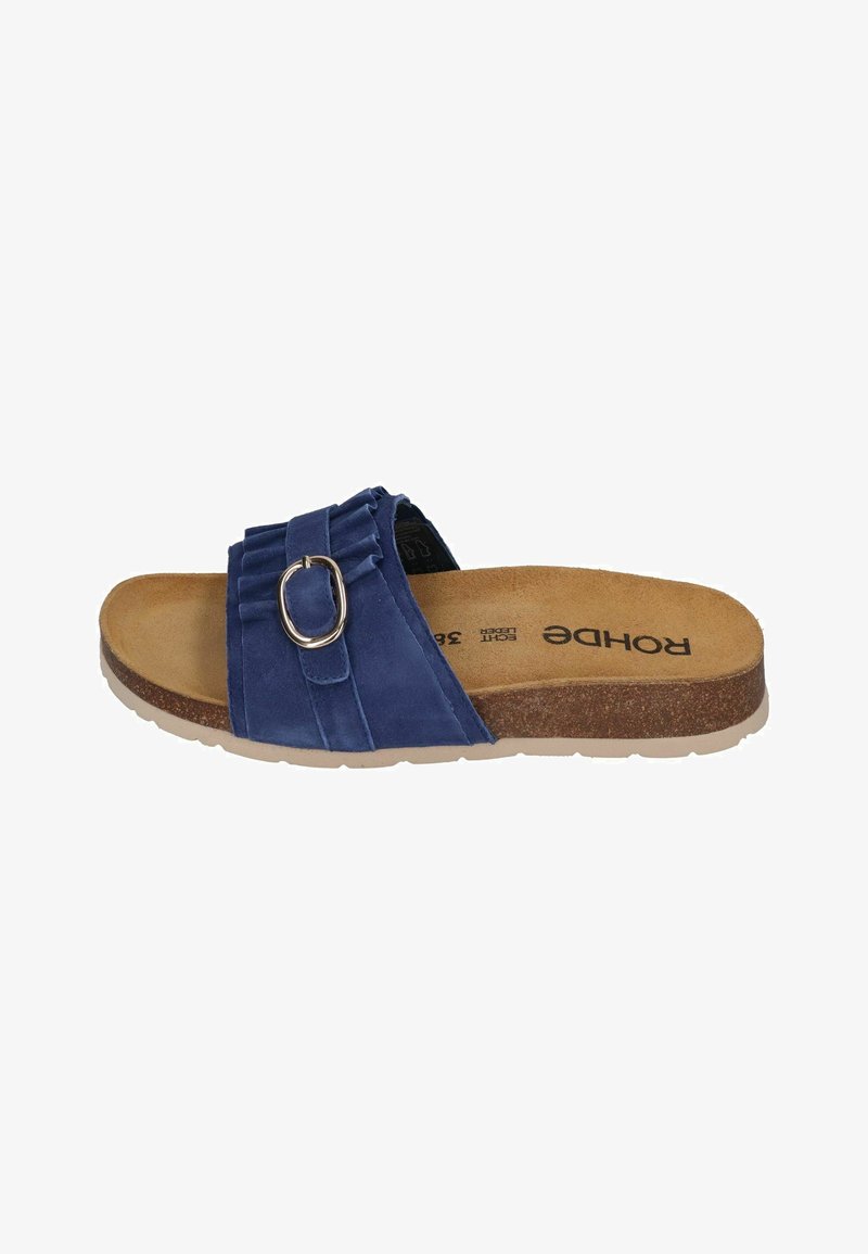 Blue suede slide sandal with a ribbed upper, silver buckle accent, and a cork footbed. Flat rubber sole for comfort and stability.