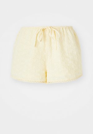 Gelbe Baumwollshorts mit elastischem Bund und Kordelzug. Verfügt über gestickte Blumenmuster und einen gewellten Saum.