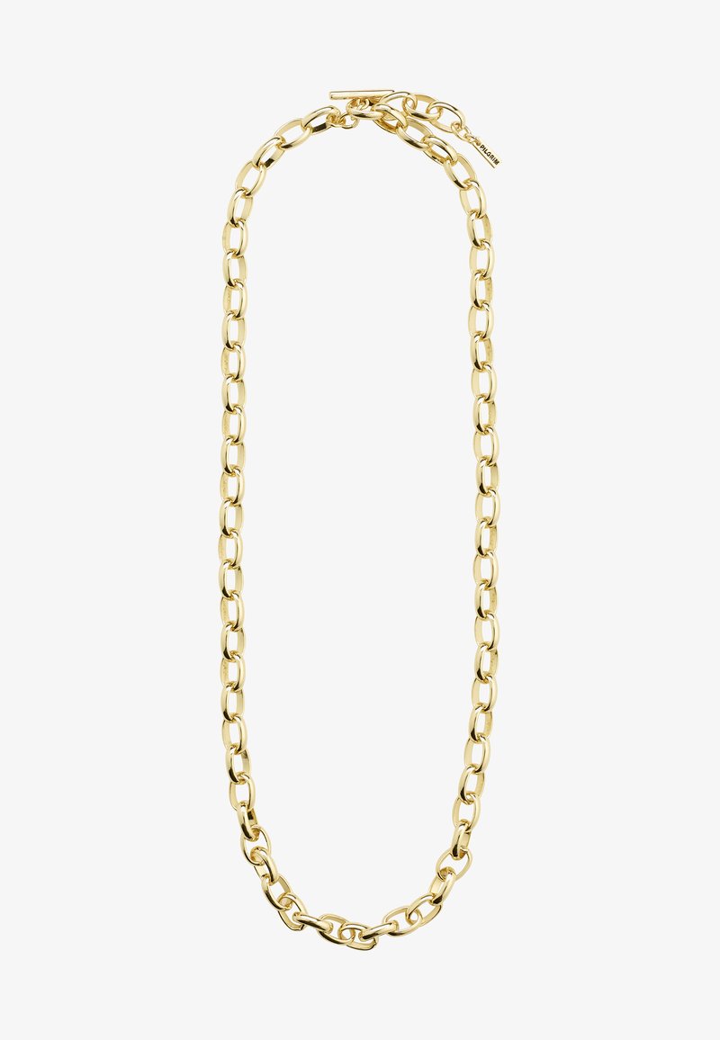 Gold bracelet featuring large, oval links with a polished surface, secured with a toggle clasp and a small tag attached.