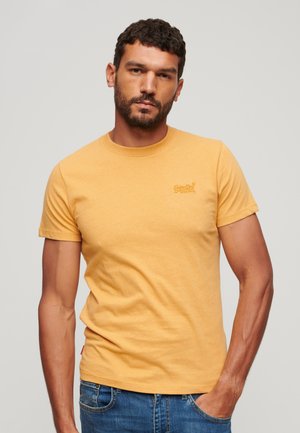 Kortærmet t-shirt med rund hals i lys gul bomuld, prydet med et lille broderet logo på venstre bryst og struktureret stof.