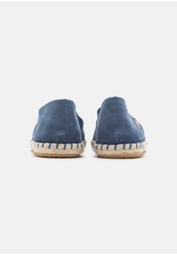 Navy blue suede shoes with braided jute soles. Back view shows rounded heel design and a small logo accent on the side.