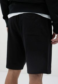 Calliope GINNICO - Pantalon de survêtement - nero