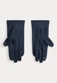 Marineblå bløde handsker lavet af elastisk materiale, med texturerede greb detaljer på fingerspidserne, glat overflade og en isoleret inderside.