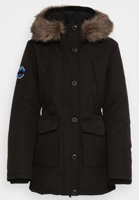 Black parka jacket with a faux fur hood, button and zipper front, two front pockets, and ribbed cuffs. Matte fabric texture with logo detail.