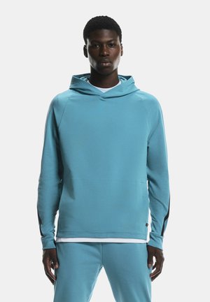 Light blue hoodie made of soft fabric with a hood, long sleeves, and a slim fit. Features black accents on the sleeves and a kangaroo pocket.
