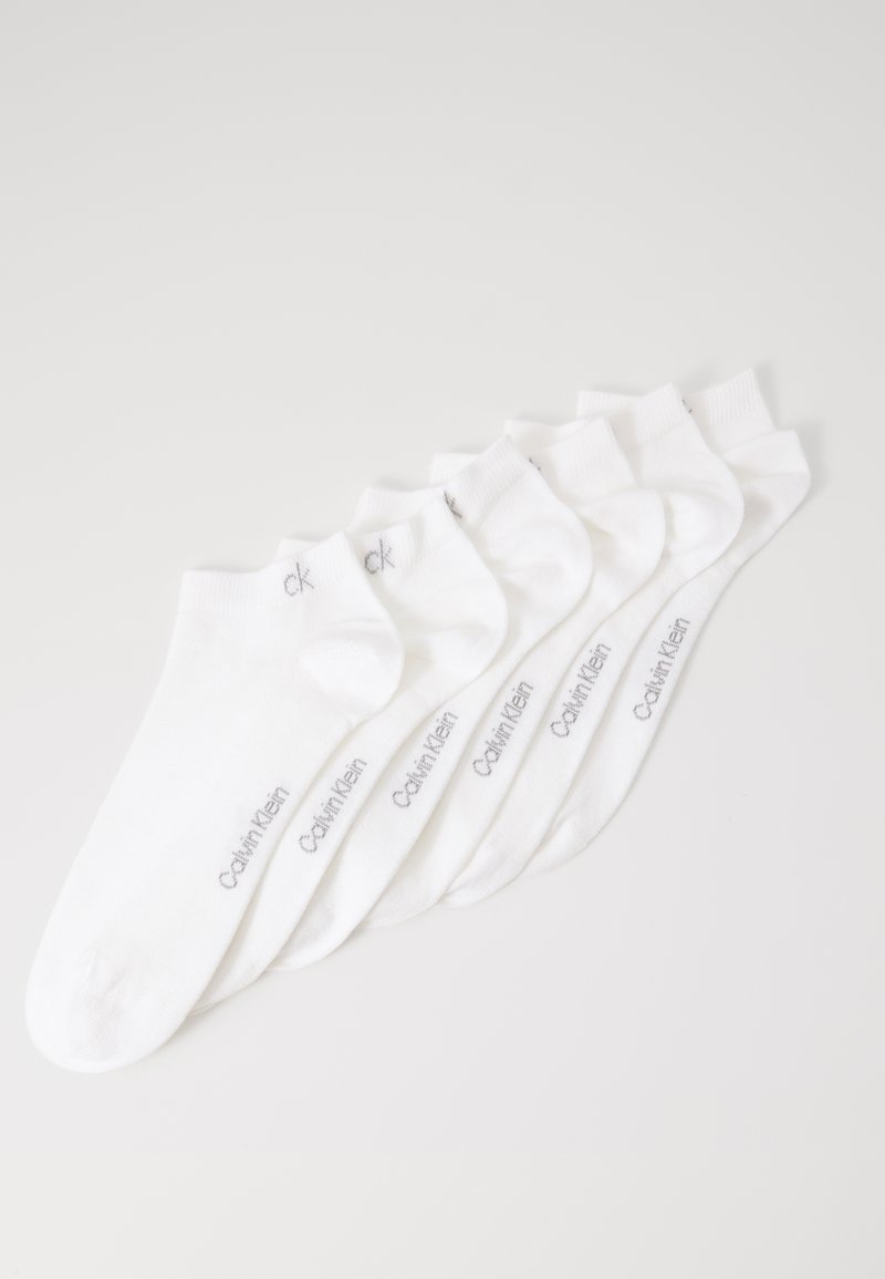 Six pairs of white ankle socks with "Calvin Klein" printed in gray on the sides, arranged overlapping on a white background.