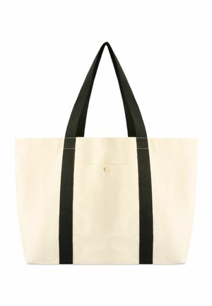 Duża beżowa torba na ramię z płótna z dwoma długimi czarnymi uchwytami rozciągającymi się od podstawy do górnych krawędzi, mała przednia kieszeń na środku.