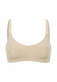 Beige sömlös bh med mjuk textur, breda axelband och rund halsringning. Enkel design utan synlig utrustning eller detaljer.