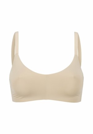 Beige nahtloser BH mit weicher Textur, breiten Trägern und Rundhalsauschnitt. Schlichtes Design ohne sichtbare Beschläge oder Akzente.